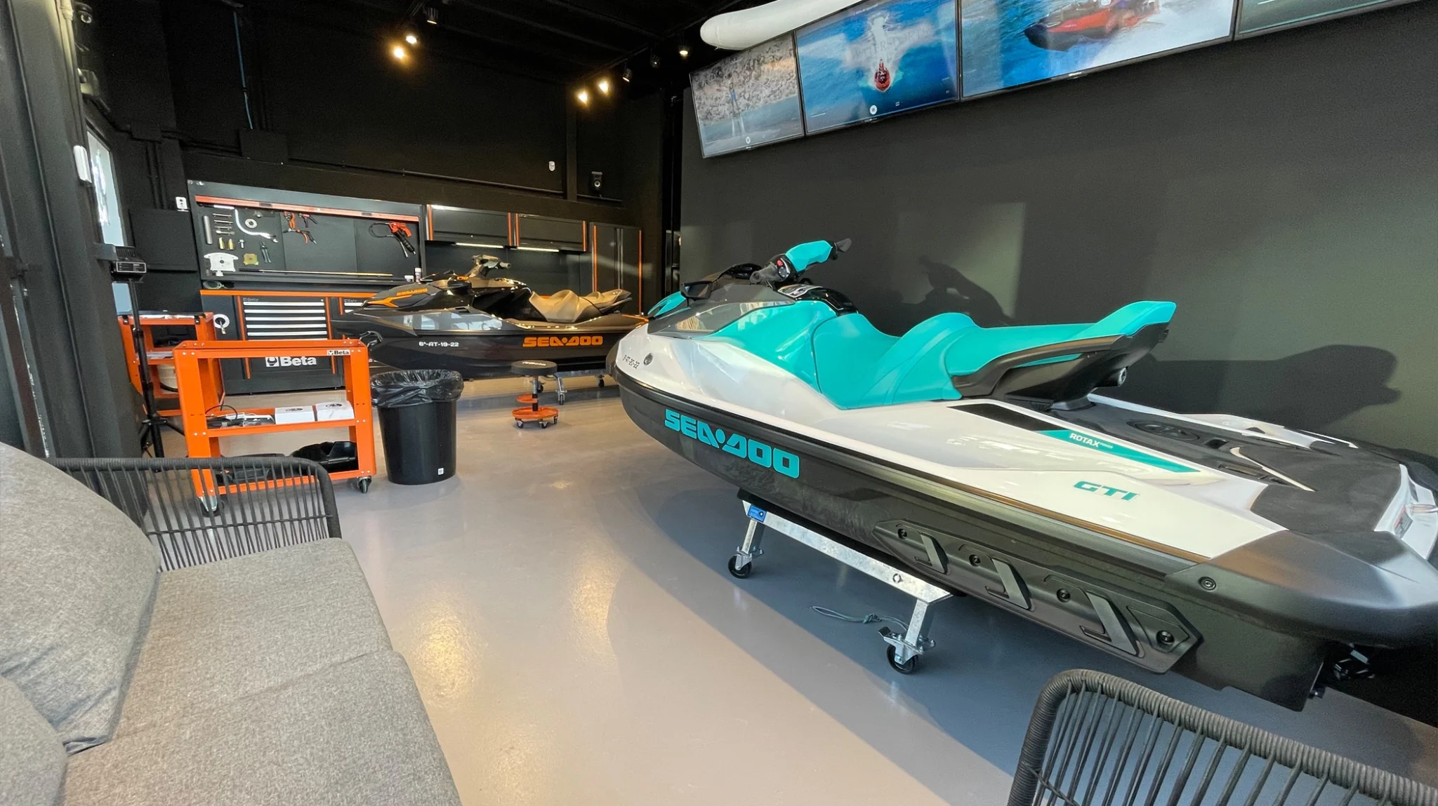 Sea-Doo jet ski fleet inside jetski.club maintenance workshop in Ibiza