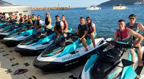 12 aligned Sea-Doo jet skis on floating platform with clients in Marina Santa Eulalia Ibiza