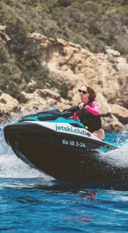 Woman riding a jet ski during a no-license jet ski tour with jetski.club along the coast of Ibiza