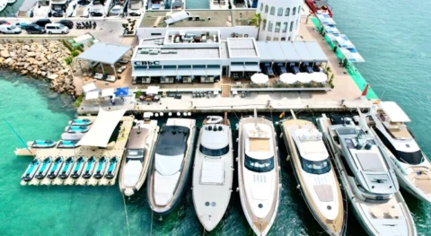 Aerial view of Marina Santa Eulalia Ibiza with luxury yachts, CBbC Marina Beach Club and jetski.club jet ski platform