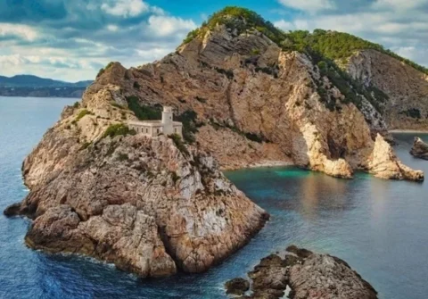 Punta Grossa lighthouse Cala San Vicente Ibiza coastline where dolphins are often seen during jet ski tours