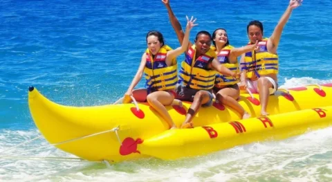Banana boat inflatable ride in Ibiza with group of people on the water