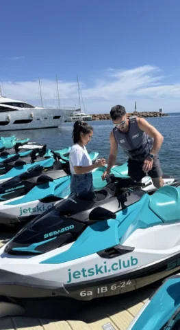Customer receiving jet ski safety briefing on floating platform in Marina Santa Eulalia Ibiza