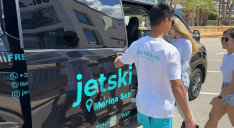 JetSki Club Ibiza driver opening transfer van door for guests before jet ski tour in Ibiza
