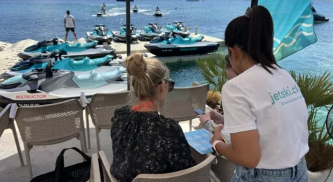 Hostess assisting clients on premium jet ski platform with Sea-Doo jet skis in Marina Santa Eulalia Ibiza