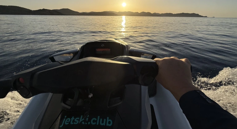 First-person view during a Sunset Jet-Ski Tour in Ibiza with Ibiza Island and the sunset in the background