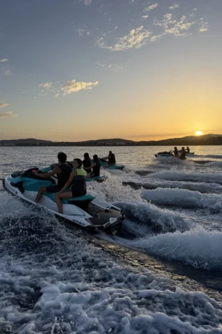 Group of jet skis cruising at sunset during a Sunset Jet-Ski Tour in Ibiza
