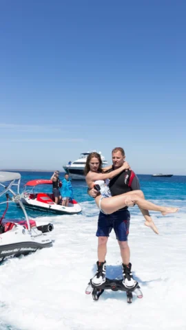 Lindsay McQueen and Anastasia McQueen performing flyboard in Ibiza with Yacht Watersports Ibiza boats in the background.