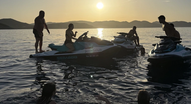Guests swimming around jet skis near Tagomago Island during a Sunset Jet-Ski Tour in Ibiza