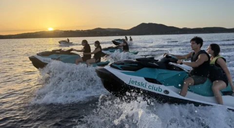 Three jet skis riding at sunset in Ibiza in September